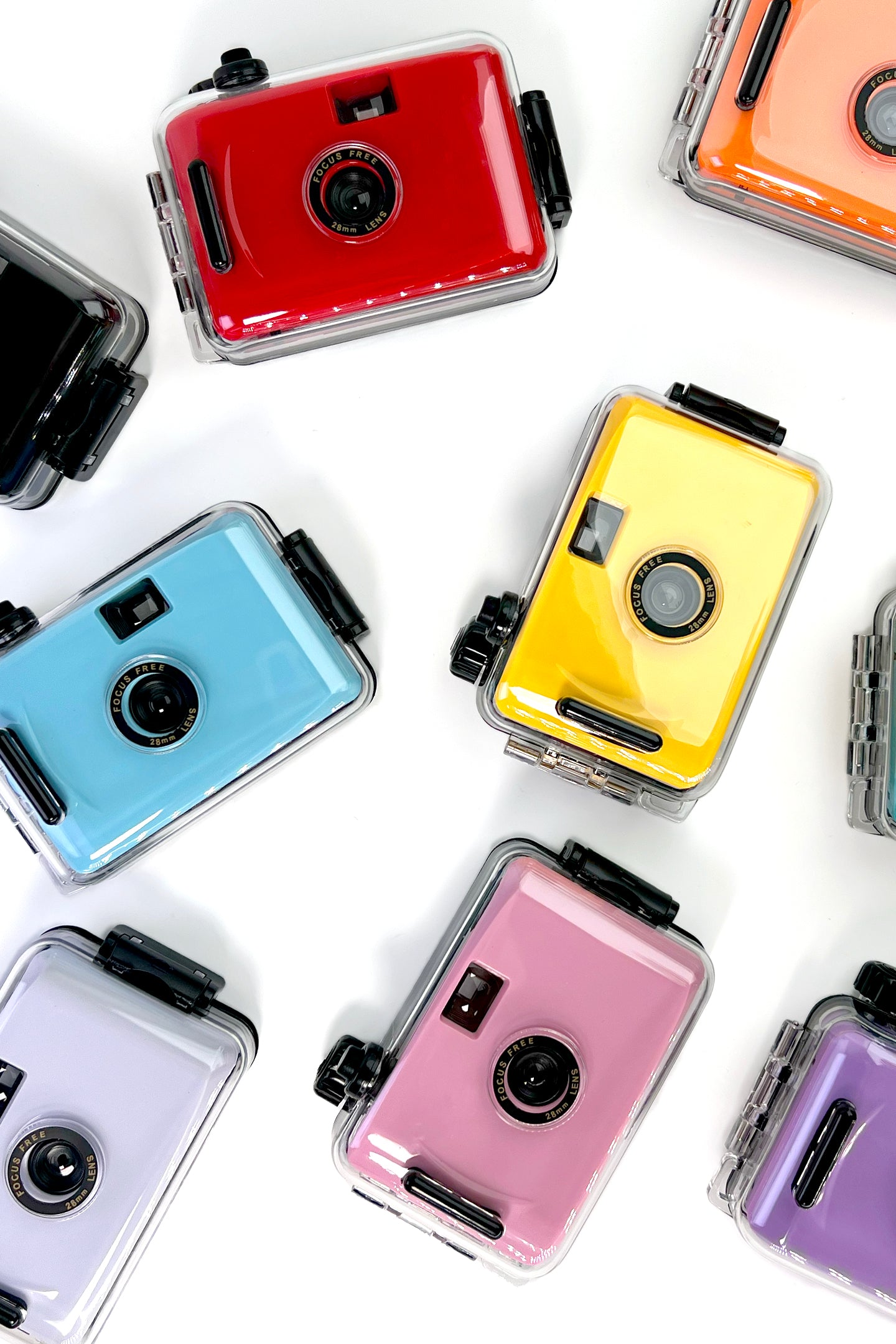 Colorful reusable film cameras arranged on a white background