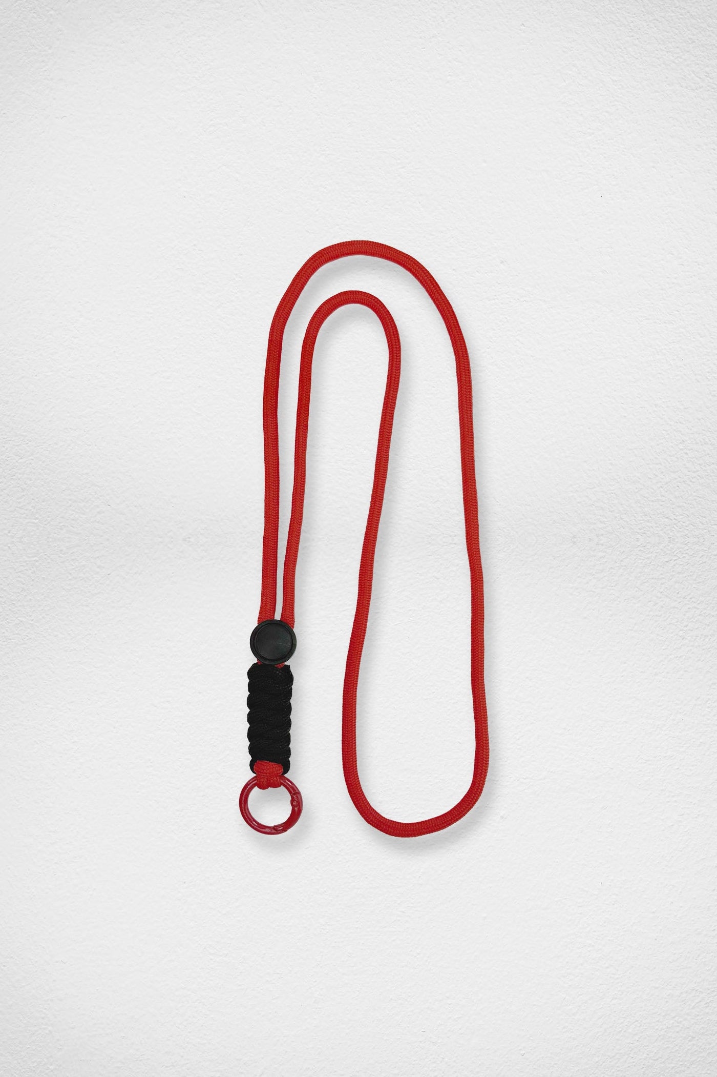 Red lanyard with a black knot on a white background