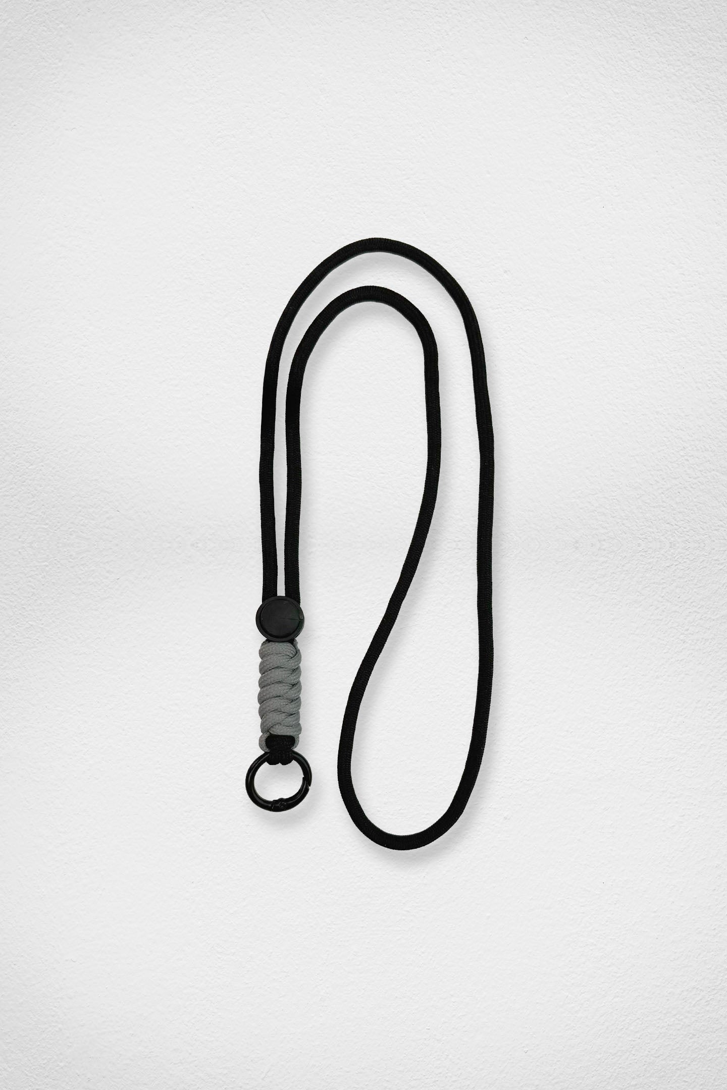 Black lanyard with gray accent on a white background